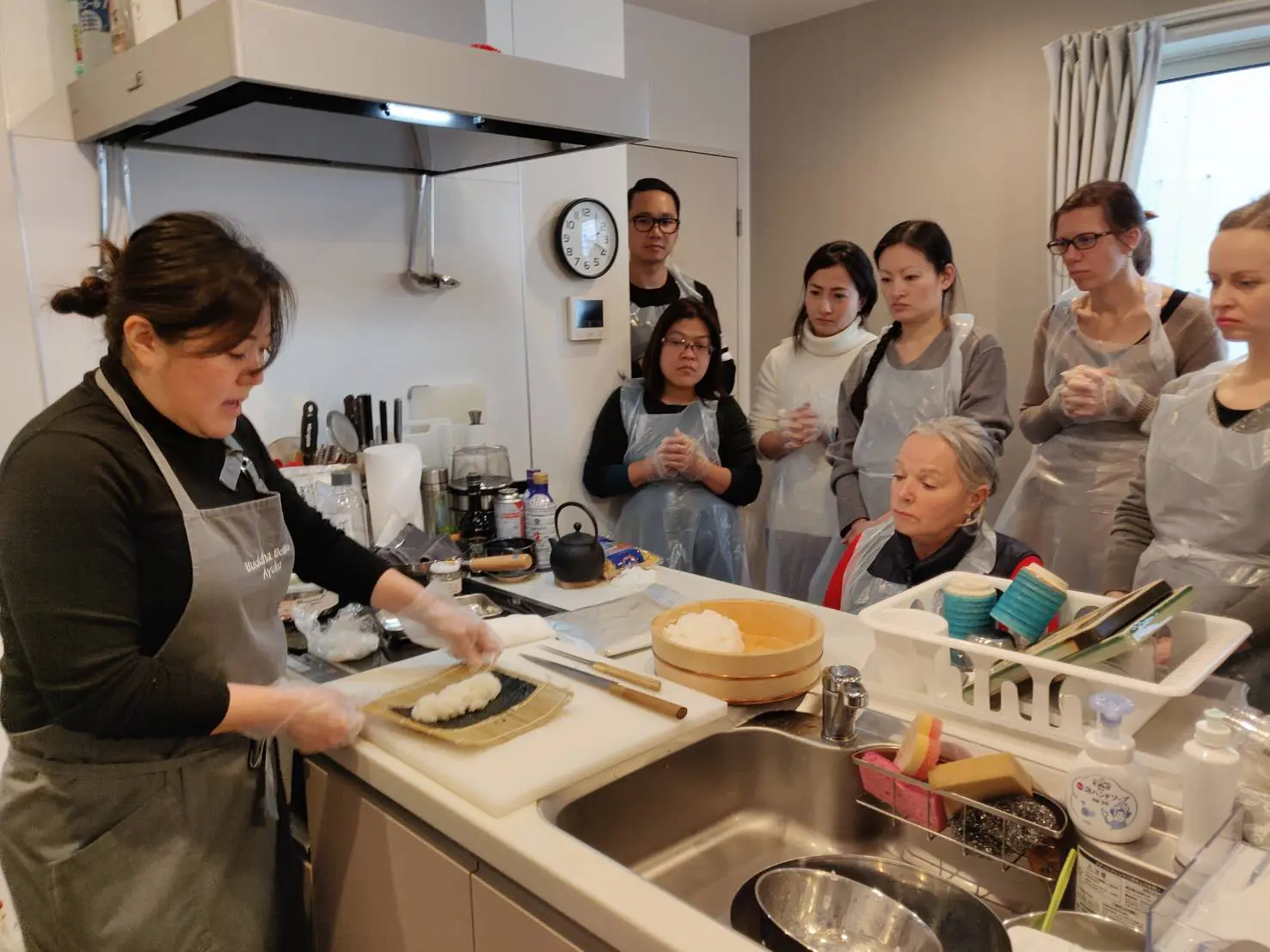 The Ohana team eagerly looks on Ayako- san’s demonstration.
